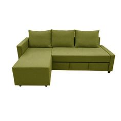 a green couch with two pillows on it and a footstool in the middle