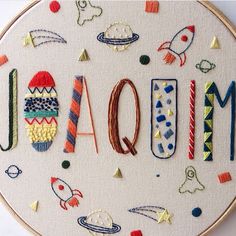 an embroidered hoop with the word mom spelled out in different colors and shapes on it