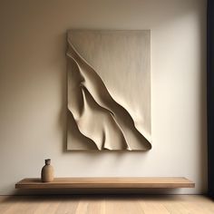 an abstract painting hangs on the wall next to a wooden shelf