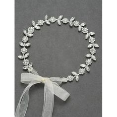 a white necklace with bows and crystal stones