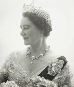 an old black and white photo of a woman wearing a tiara