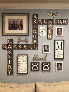 a living room filled with lots of pictures and frames on the wall next to a couch