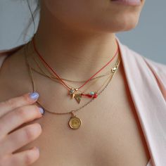 Introducing our Evil Eye Tassel Necklace, a top-seller from Sunday Forever. This must-have piece features an evil eye and small red tassel, available in either sterling silver or 14k gold filled. Wear it alone for a delicate touch or pair it with other necklaces for a layered look. It also makes for a thoughtful gift, packaged in our signature snap case and drawstring Nice Things pouch, complete with a description card. Plus, the chain can be easily adjusted from 15" to 17.5" for the perfect fit Charm Necklace Diy, Gold Tassel Necklace, Cotton Pouch, Beads Bracelet Design, Dope Jewelry, Jewelry Outfit, Jewelry Holder, Nice Things, Top Seller