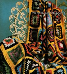 an old crocheted afghan is displayed on a chair