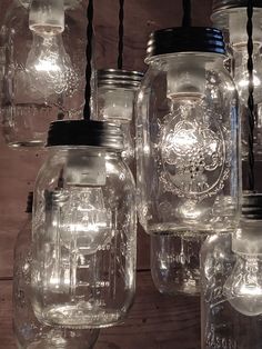 many mason jars are hanging from the ceiling