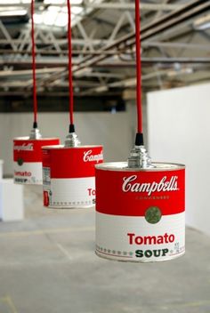 three campbells tomato soup cans hanging from hooks