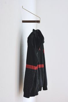 a black and red jacket hanging on a wall