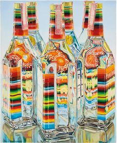 three bottles with different colors on them sitting next to each other in front of a blue sky