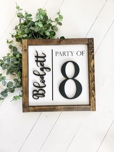 a sign that says party of eight on it next to a potted green plant