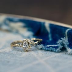 two rings sitting on top of a blue and white cloth