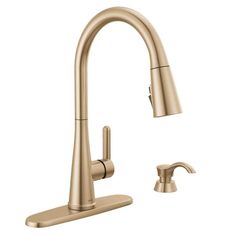 an image of a kitchen faucet with the pull out sprayer in brushed brass