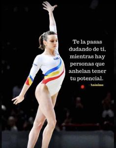 a woman is doing gymnastics on the balance beam