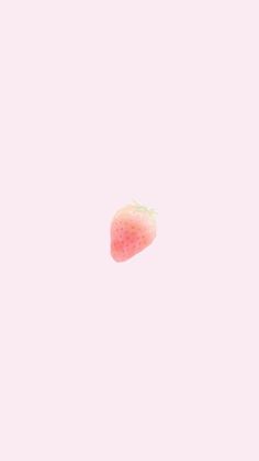 a single strawberry is in the air on a pink background with white space for text