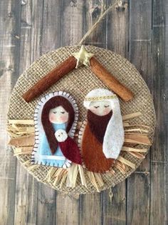 a nativity ornament hanging on a wooden wall