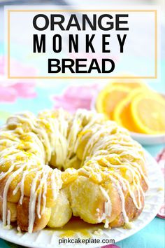 an orange monkey bread on a plate with icing and lemons in the background