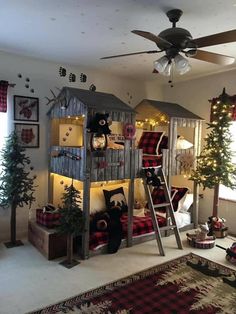 the room is decorated for christmas and has a loft bed with ladders on it