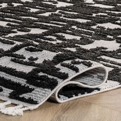 a black and white rug is laying on the floor