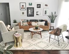 a living room filled with furniture and pictures on the wall