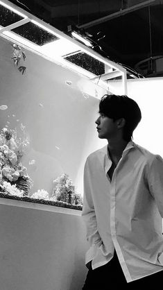 a man standing in front of an aquarium