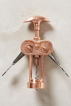 a pair of scissors are attached to a pink metal object with two holes in the middle