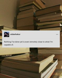 a pile of books sitting on top of a wooden table