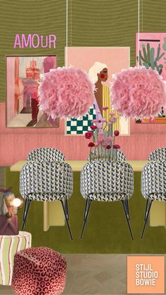 an image of a woman sitting at a table with two pink pom poms