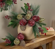 a vase filled with christmas decorations on top of a wooden table