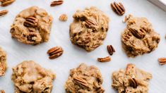 several cookies with pecans scattered around them