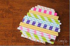 several different colored paper straws stacked on top of each other with polka dots and stripes