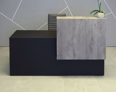 an office desk with a potted plant on top