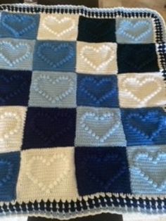 a blue and white blanket with hearts on it