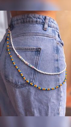 the back of a woman's jeans with colorful beads on her waist and belly