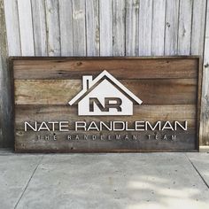 a wooden sign with the name of a residential team on it in front of a building