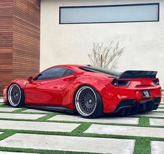 a red sports car parked in front of a building