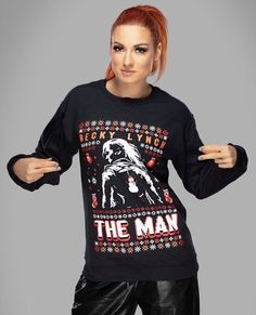 a woman with red hair wearing a black sweater that says, the man on it