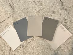 four different shades of paint sitting on top of a granite countertop next to each other