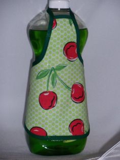 a green and red bottle with cherries on it