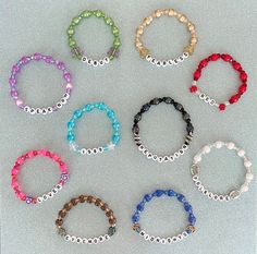 six different colored bracelets with beads on them