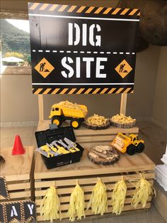 there is a sign that says dig site with construction vehicles on it and other items