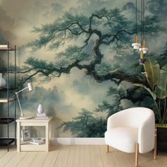 a living room with a large wall mural and white chair in front of the tree