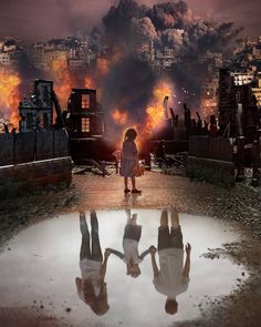 a girl standing in front of a fire with her reflection on the ground and buildings behind her