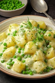 a white plate topped with potatoes and peas