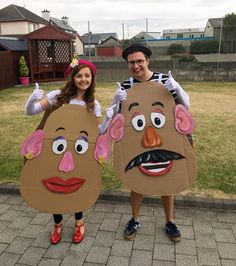 two people dressed in costumes standing next to each other on a brick walkway with grass behind them