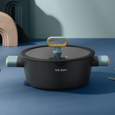 a black and blue pot sitting on top of a blue floor