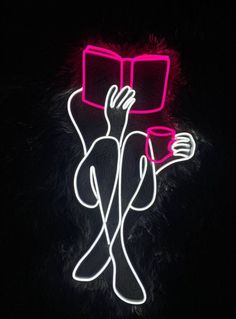 a neon sign that is lit up in the dark with headphones attached to it