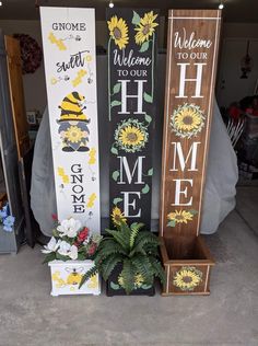 three wooden signs with sunflowers and welcome to our home, one is painted