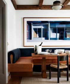 a dining room table with two chairs and a bench