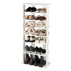 a white shoe rack with several pairs of shoes