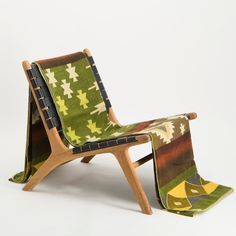 a wooden chair with green and yellow fabric on it