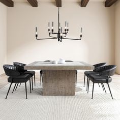 a dining room table with black chairs and a chandelier